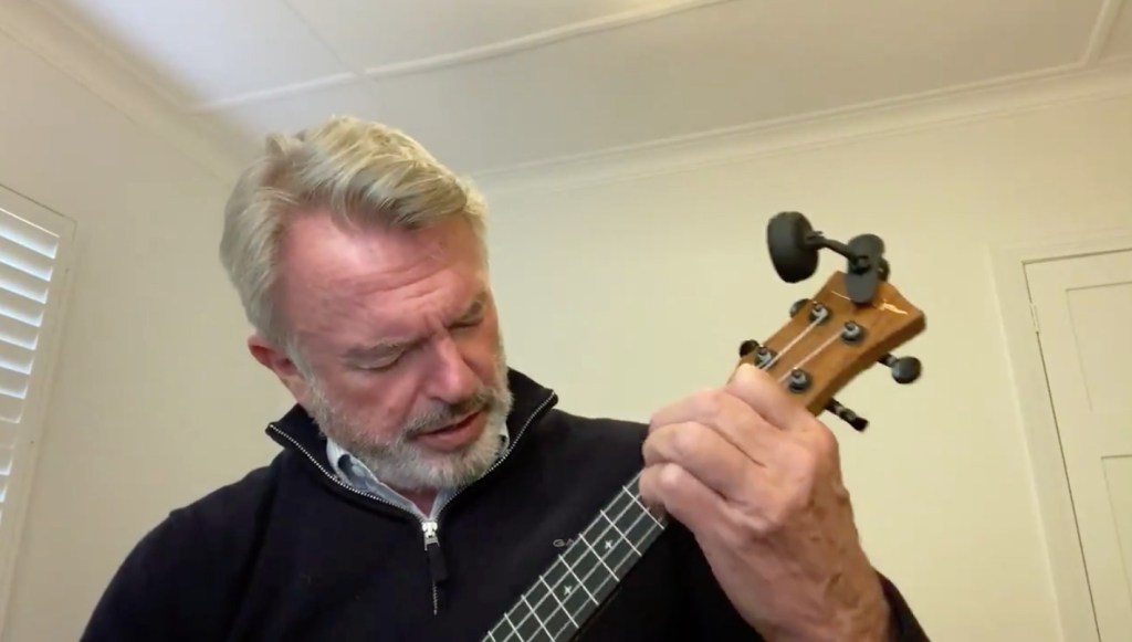 Sam Neill playing 'Uptown Funk' on a ukulele